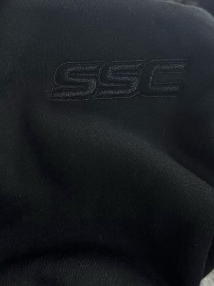 Black SSC CORE Black Tech Suit, close-up of tonal SSC embroidery on fleece.