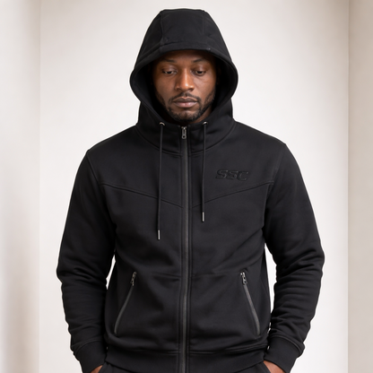 Black SSC CORE Black Tech Suit, hood-up hoodie detail on model.