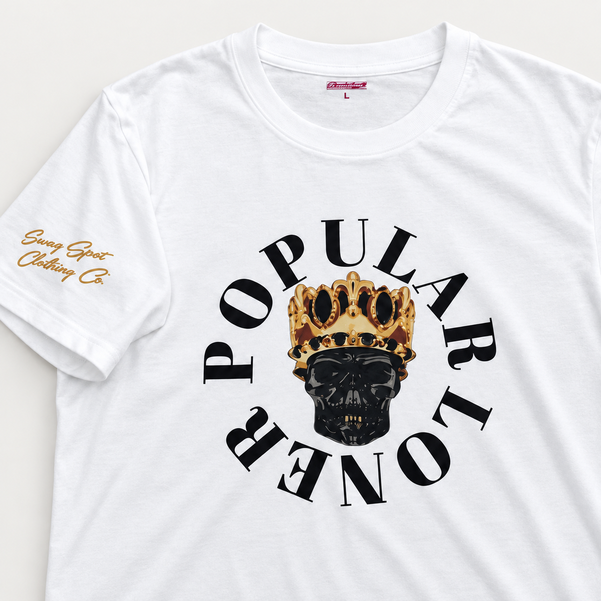 Close-up of the Gold Standard T-Shirt’s crowned skull graphic, Popular Loner lettering, and gold sleeve branding.